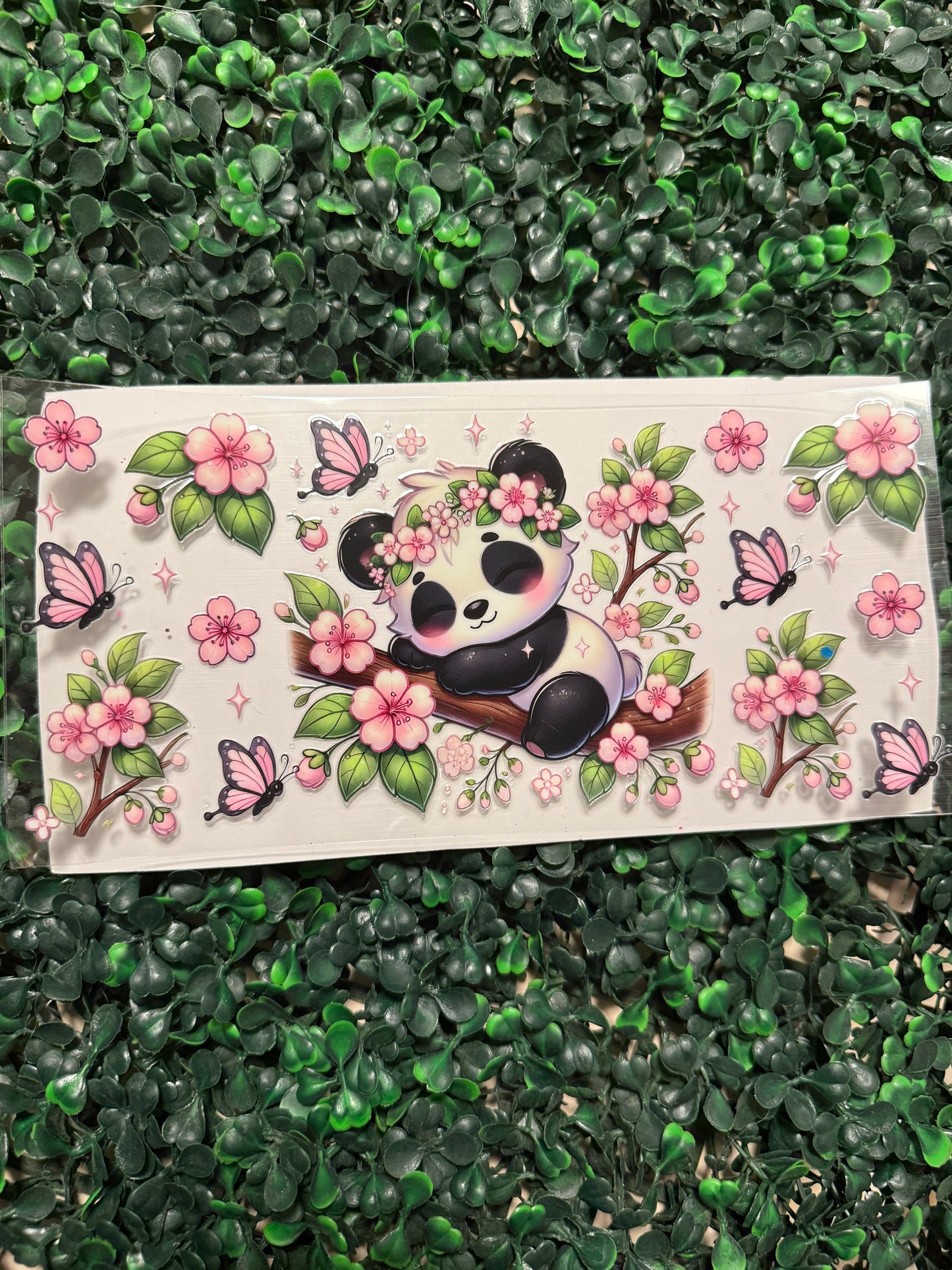 Sleepy panda with pink flowers