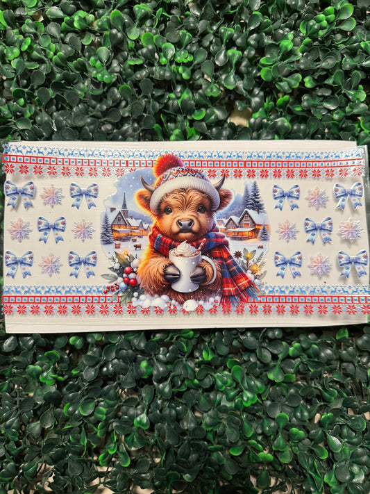 Red and blue Christmas cow drinking coco