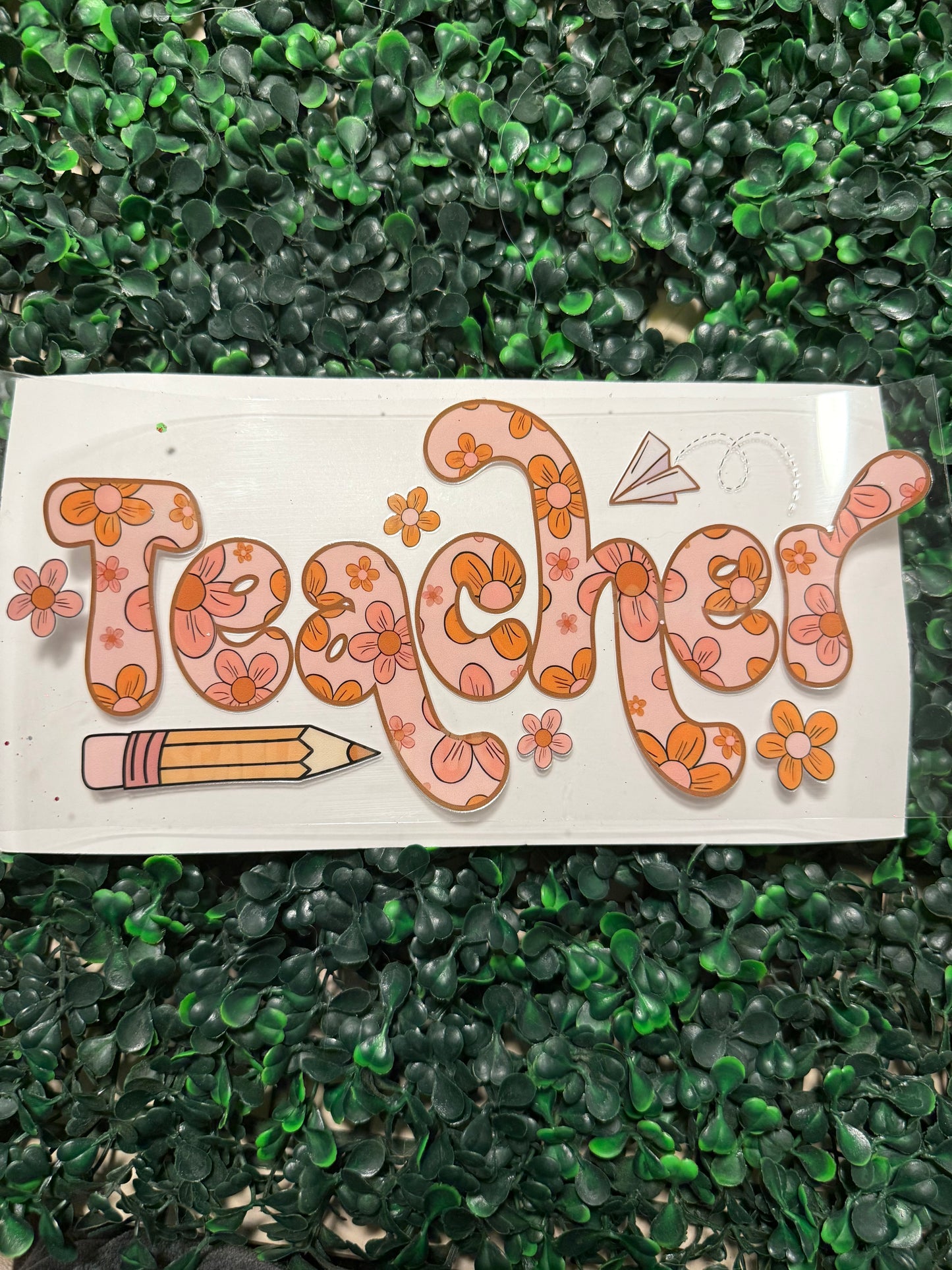 Orange floral teacher with pencil